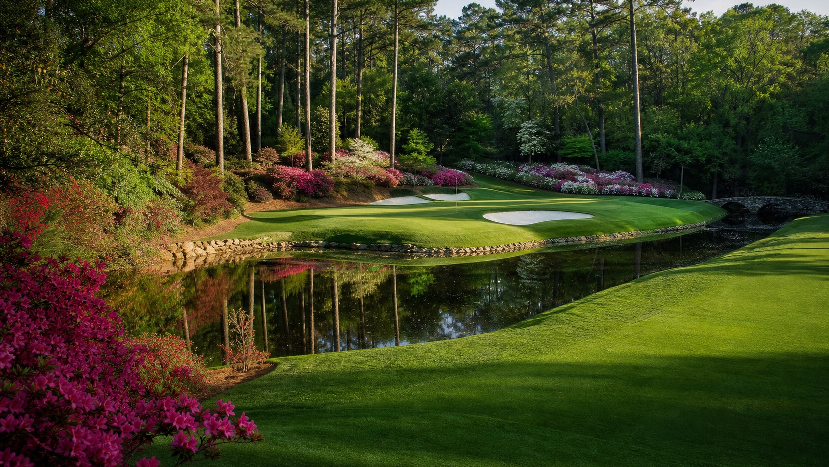 short par-three championship hole over a creek with azaleas, photographed in a wide editorial landscape