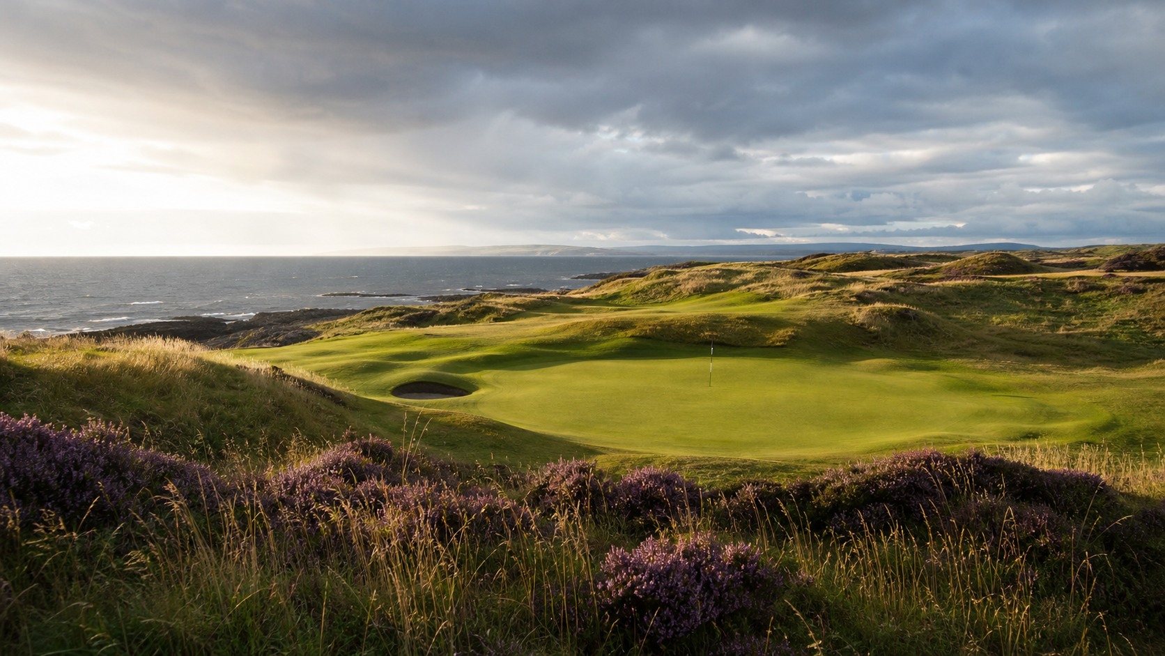 remote Scottish links course beside dunes and sea, photographed in a wide editorial landscape
